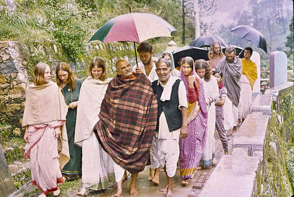 On a rainy day, Maharajji walks with his biographer, Dada Mukherjee, and young seekers from the West. Though language was a barrier, both enjoyed the encounters. durga mayi ma ashram