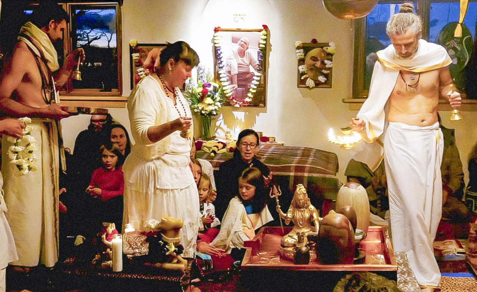 At the Hanuman Temple in Taos, New Mexico, devotees offer arati to Siva during one of the devotional festivals at this remote center dedicated to Neem Karoli Baba. neem karoli ashram and taos hanuman temple